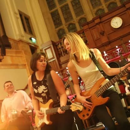 Colleagues playing electric guitars